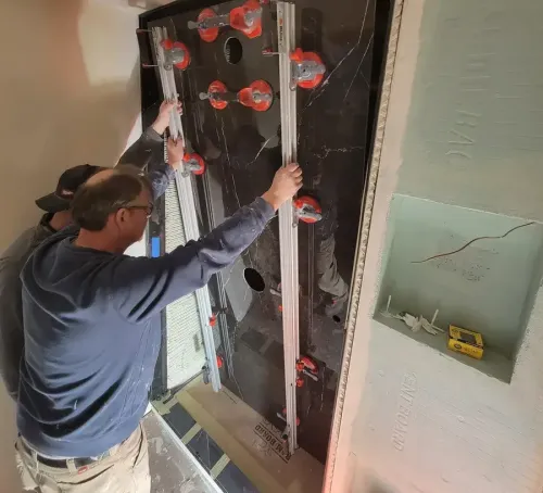 A construction worker pours materials inside a building under renovation.